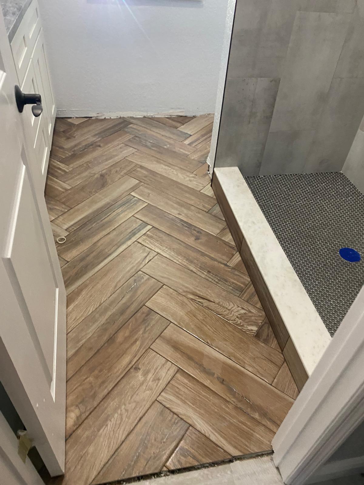 Herringbone wood-look plank tile floor