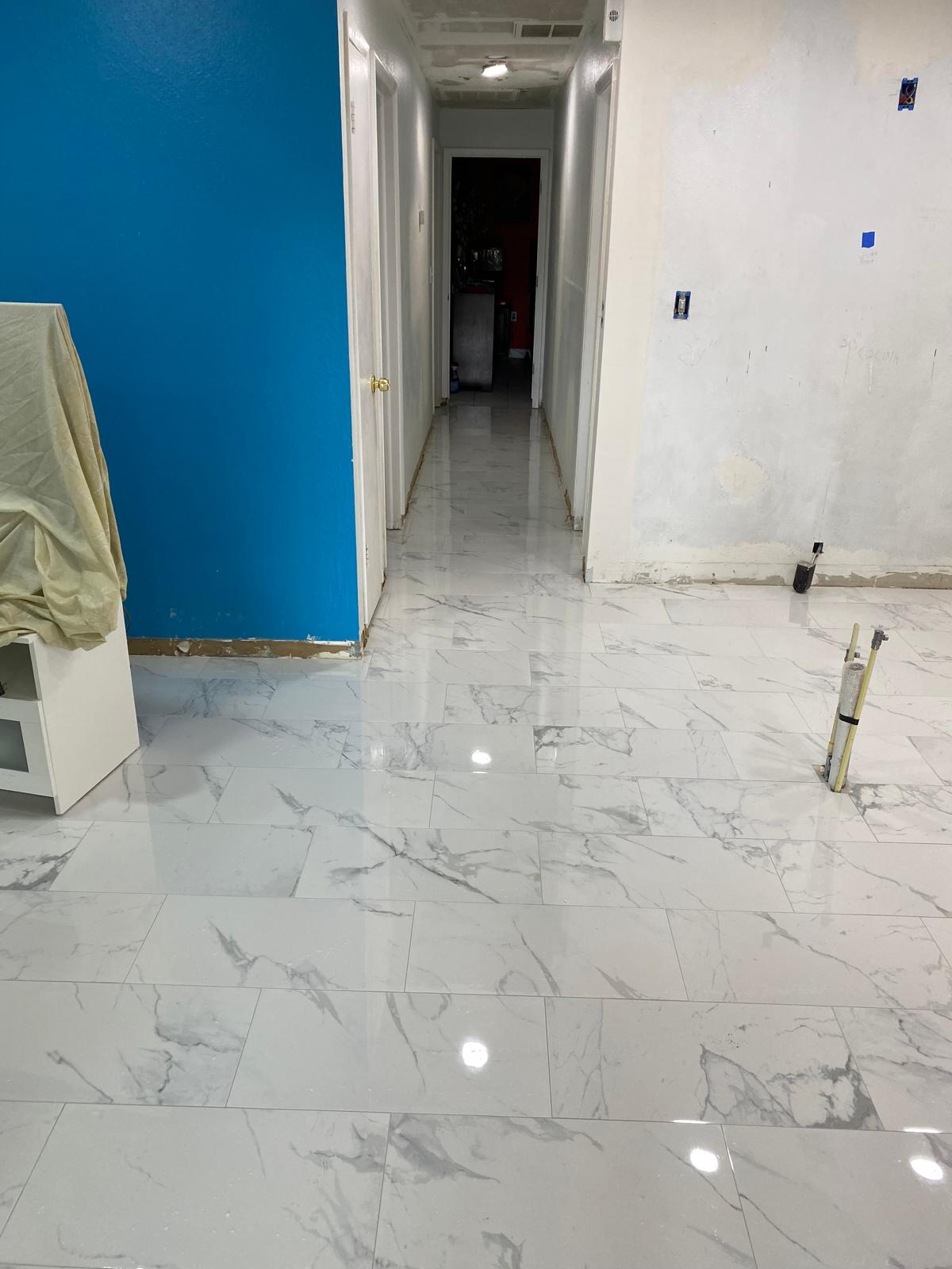 Polished marble-look porcelain floor running through a Tampa hallway