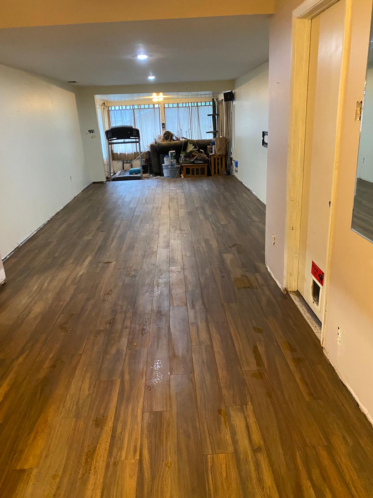 Wood-look plank tile running from an interior space toward the lanai
