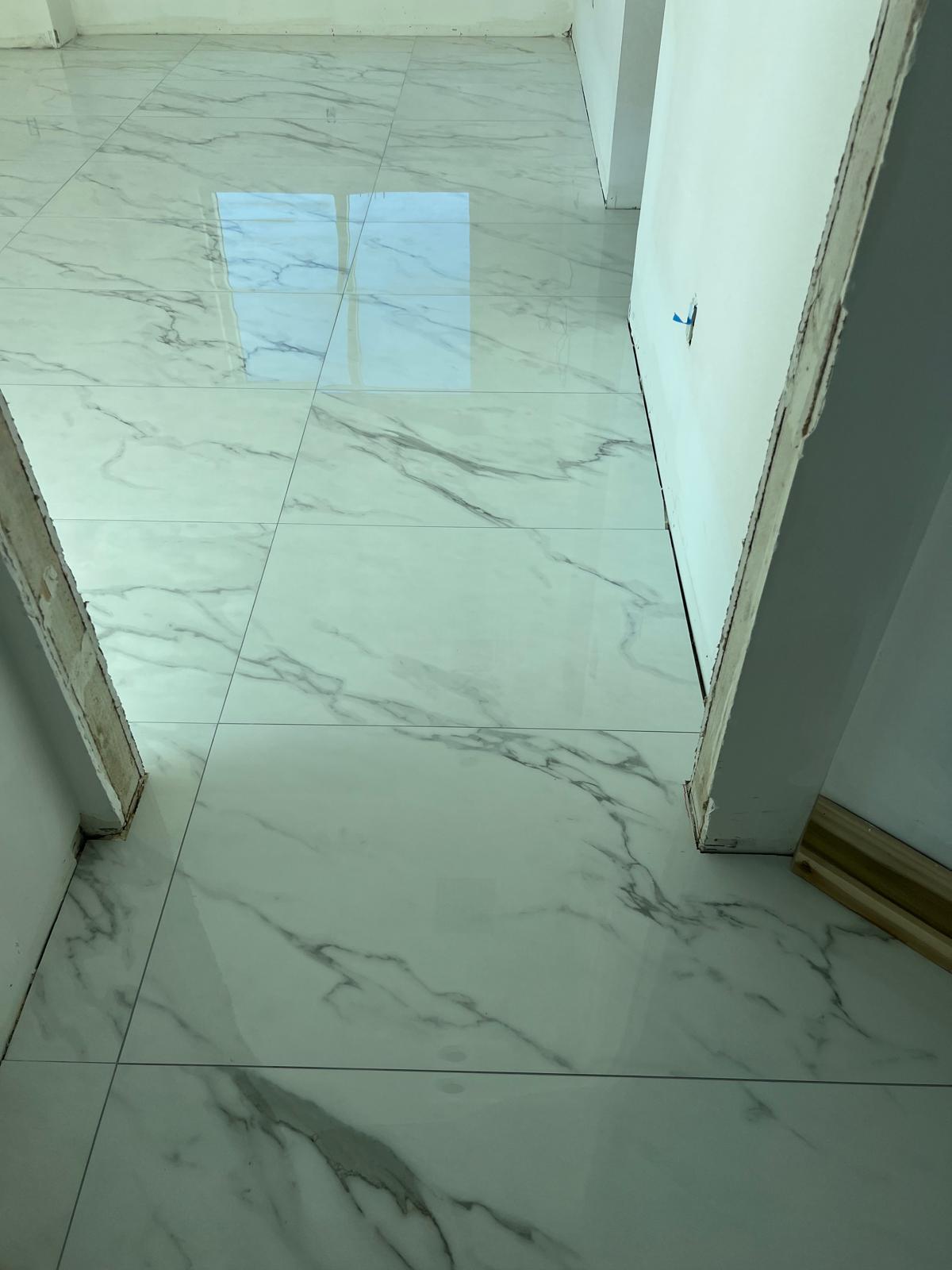 Polished porcelain floor with a flat, level transition at a doorway